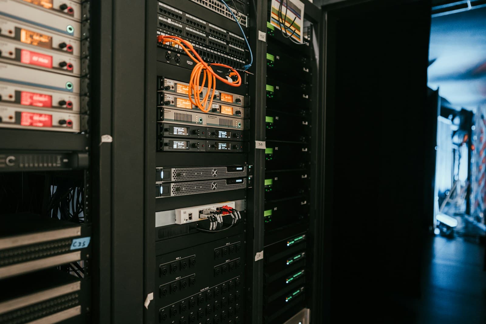A rack of servers in a dark server room