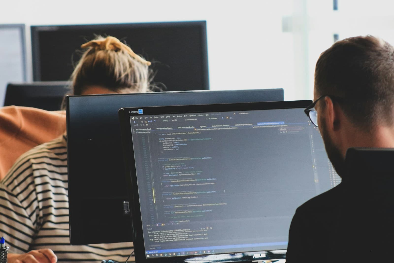 An engineer working beside a computer monitor